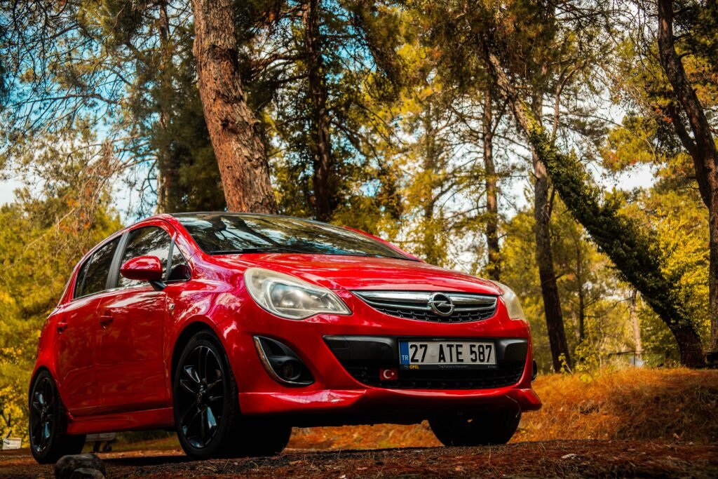 A Red Opel Corsa in an Autumnal Forest